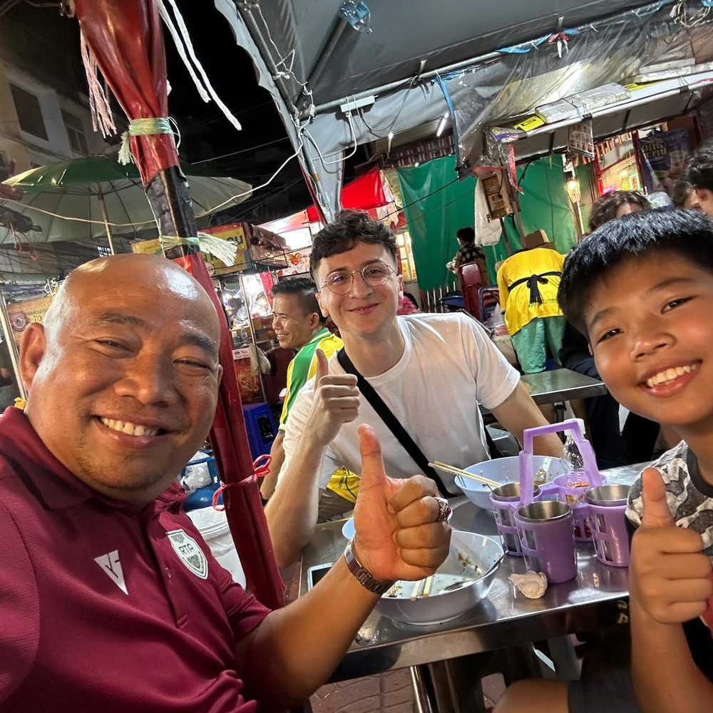 With friendly locals at a market in Chiang Mai, Thailand